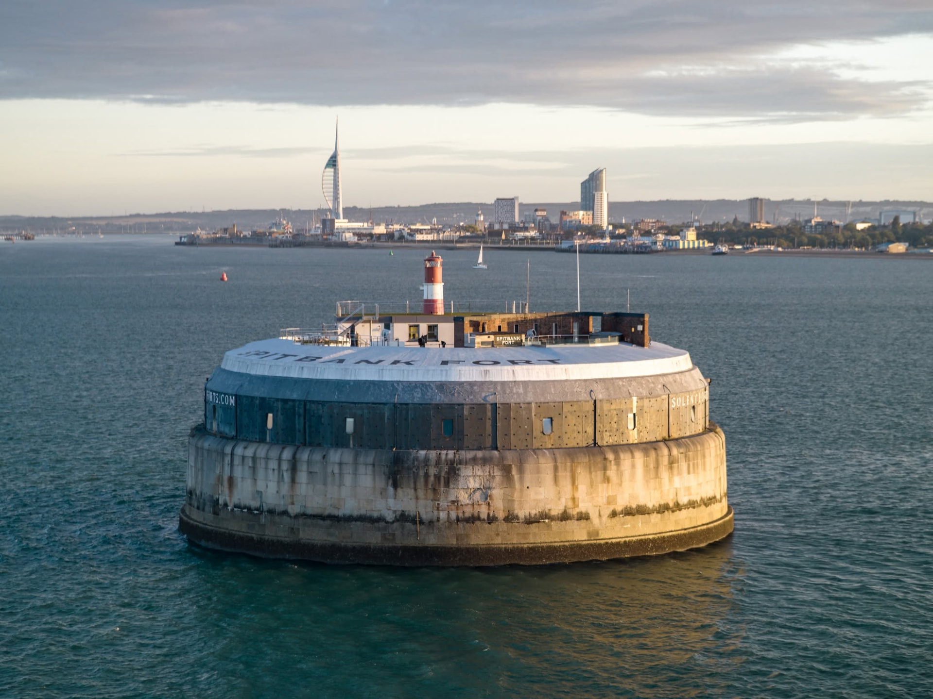 Aerial view of Spitbank Fort in the Solent with the Portsmouth skyline behind.