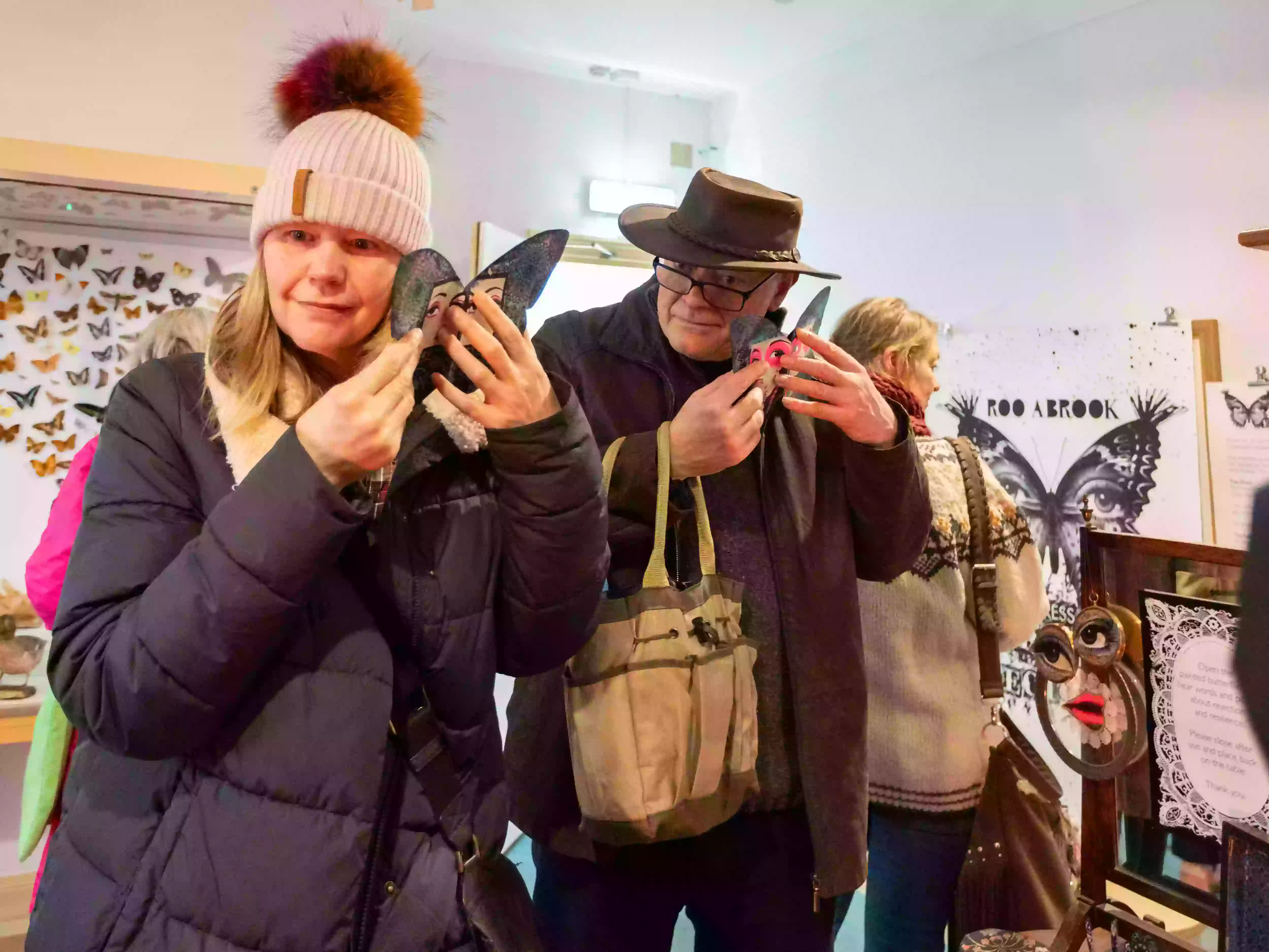 Visitors interacting with the painted butterflies in Roo Abrook's installation