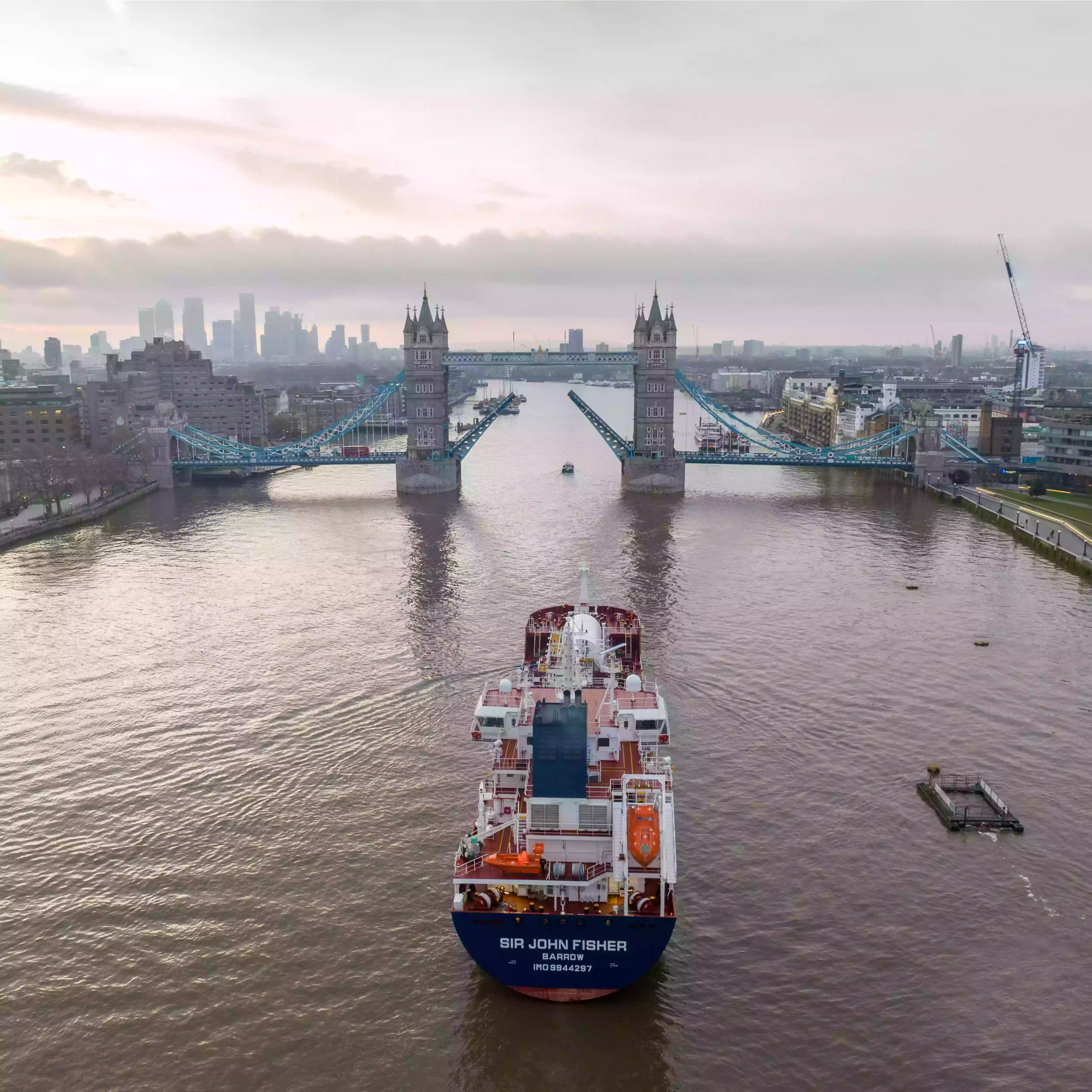 Drone view of the Sir John Fisher passing through central London on the River Thames at dawn