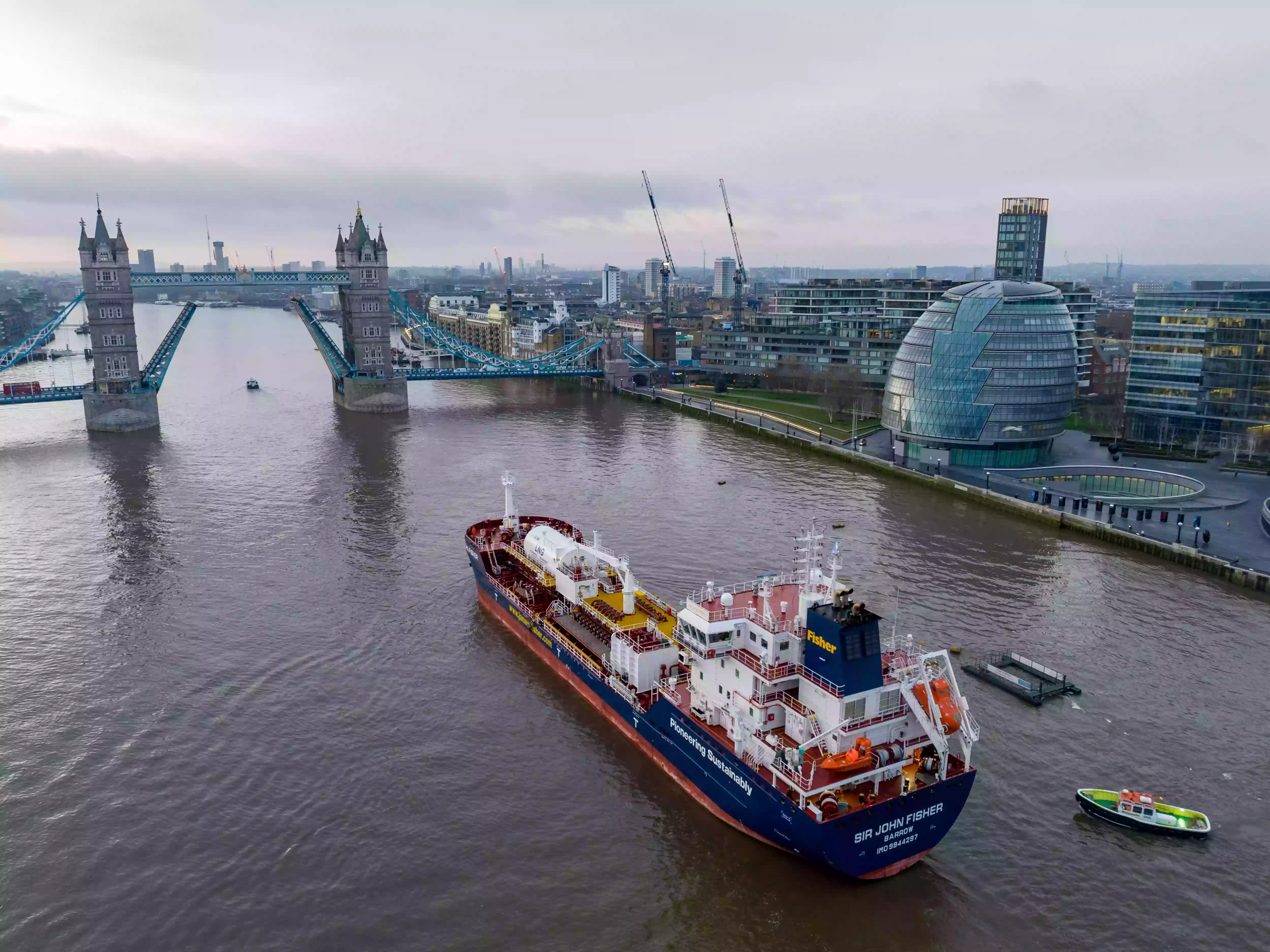 Aerial view of the Sir John Fisher chemical tanker approaching Tower Bridge in the Pool of London
