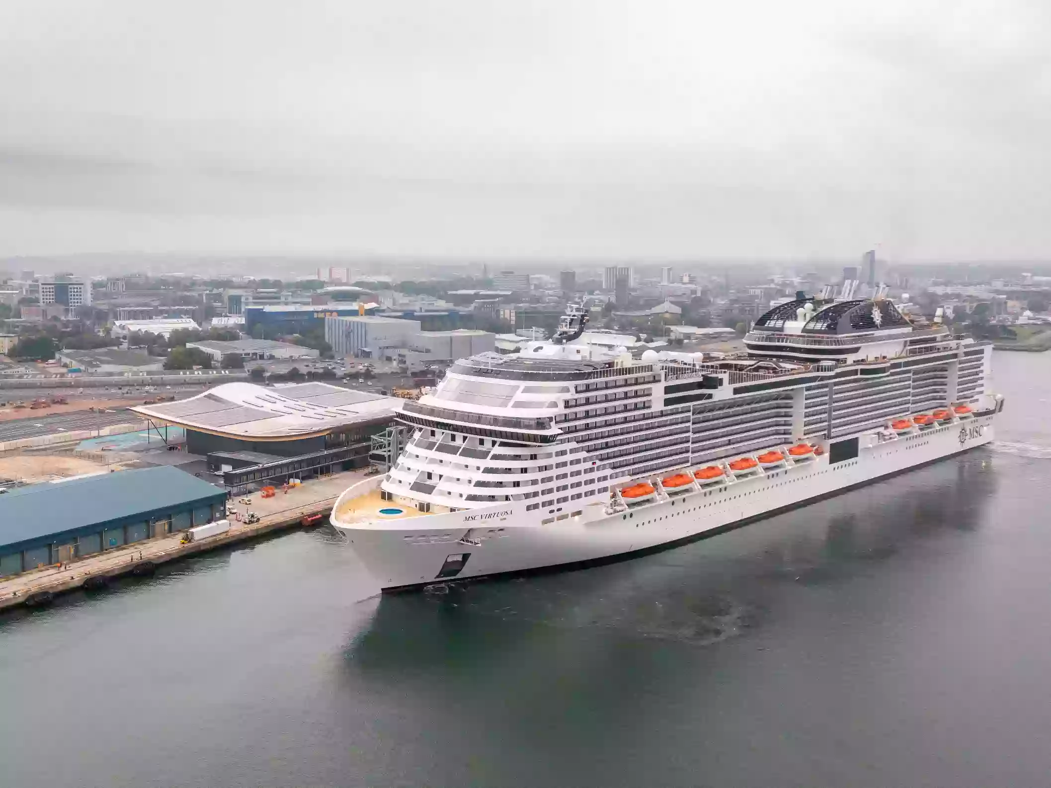 Aerial view of the Horizon Cruise Terminal and Port of Southampton with MSC Virtuosa alongside.