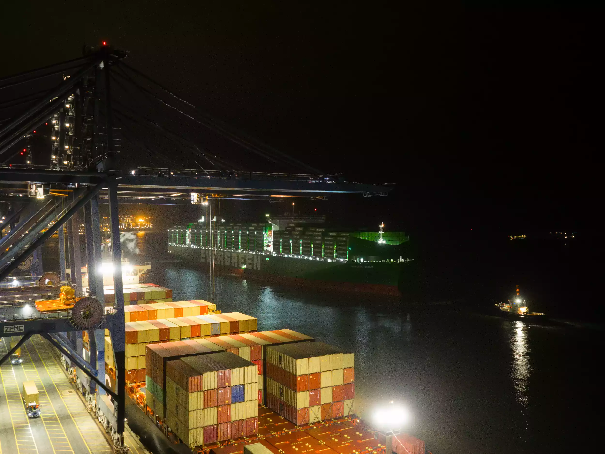 Close overhead drone shot of Ever Eco's deck and container stacks at night