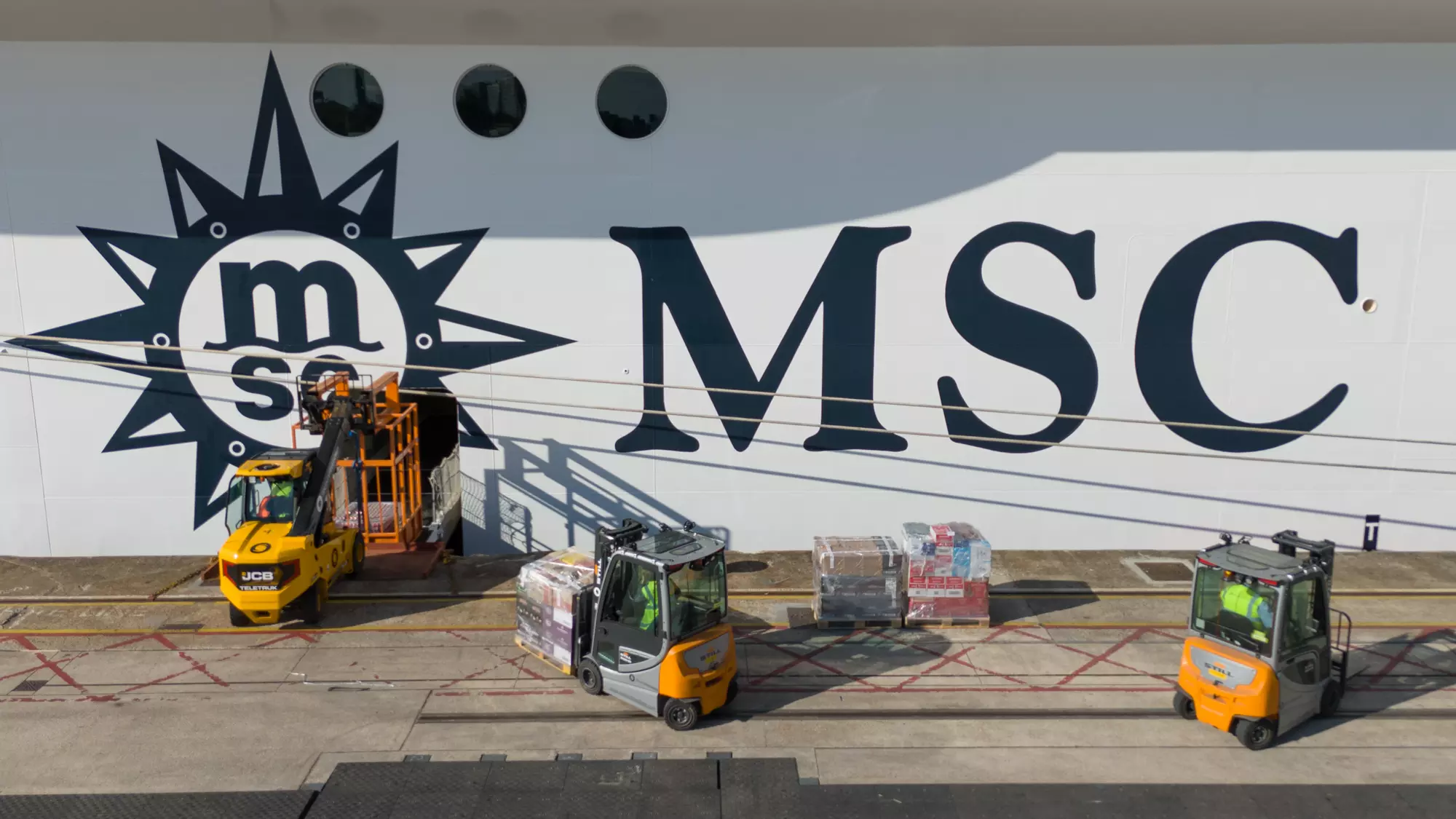 Quayside forklift operations beside the MSC logo on MSC Virtuosa’s hull in Southampton