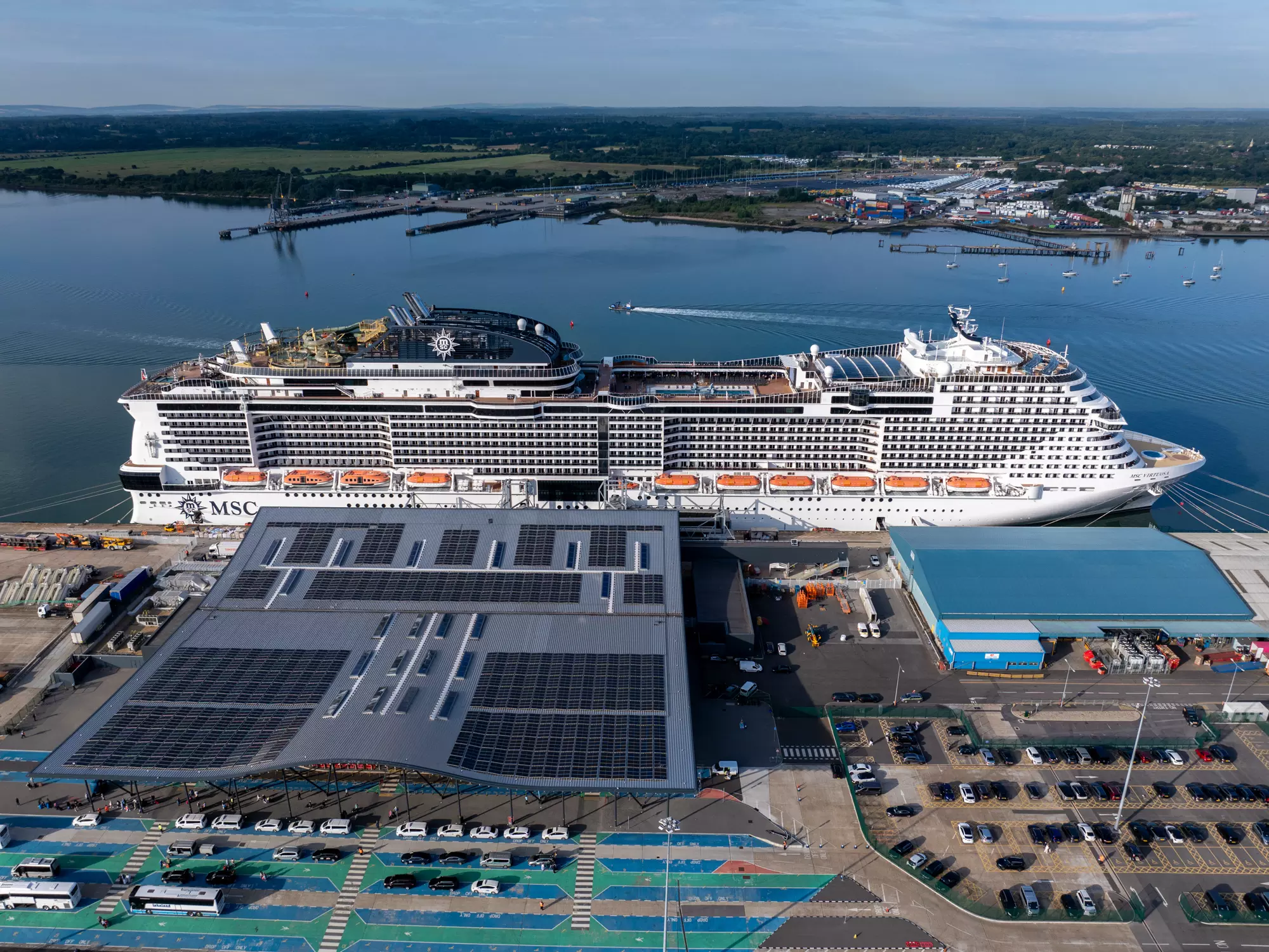 Overhead drone view of a Southampton Horizon cruise terminal with a ship alongside and the docks beyond