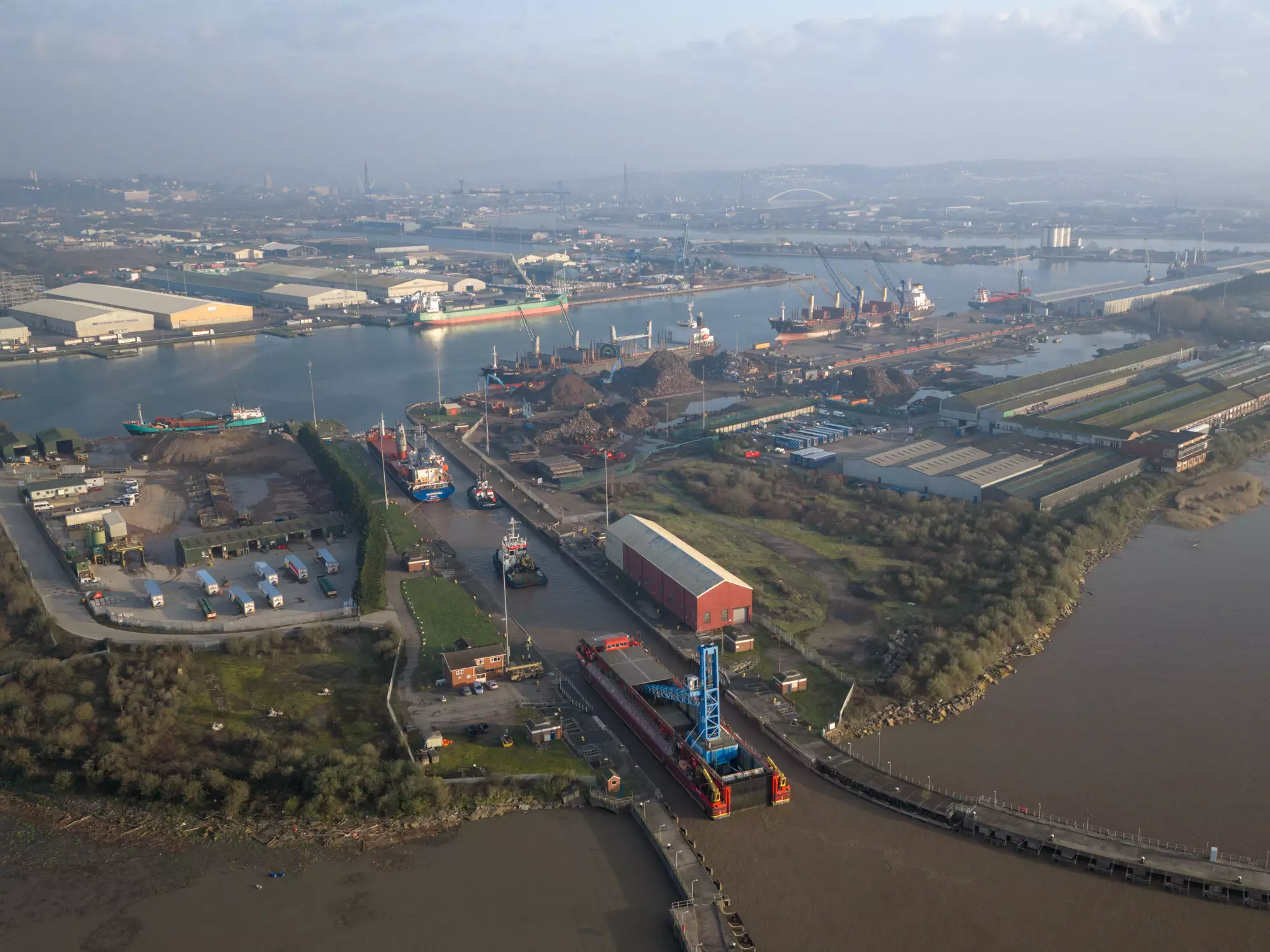 Aerial view of the Robert Wynn and Sons barge carrying crane Margaret into the Port of Newport