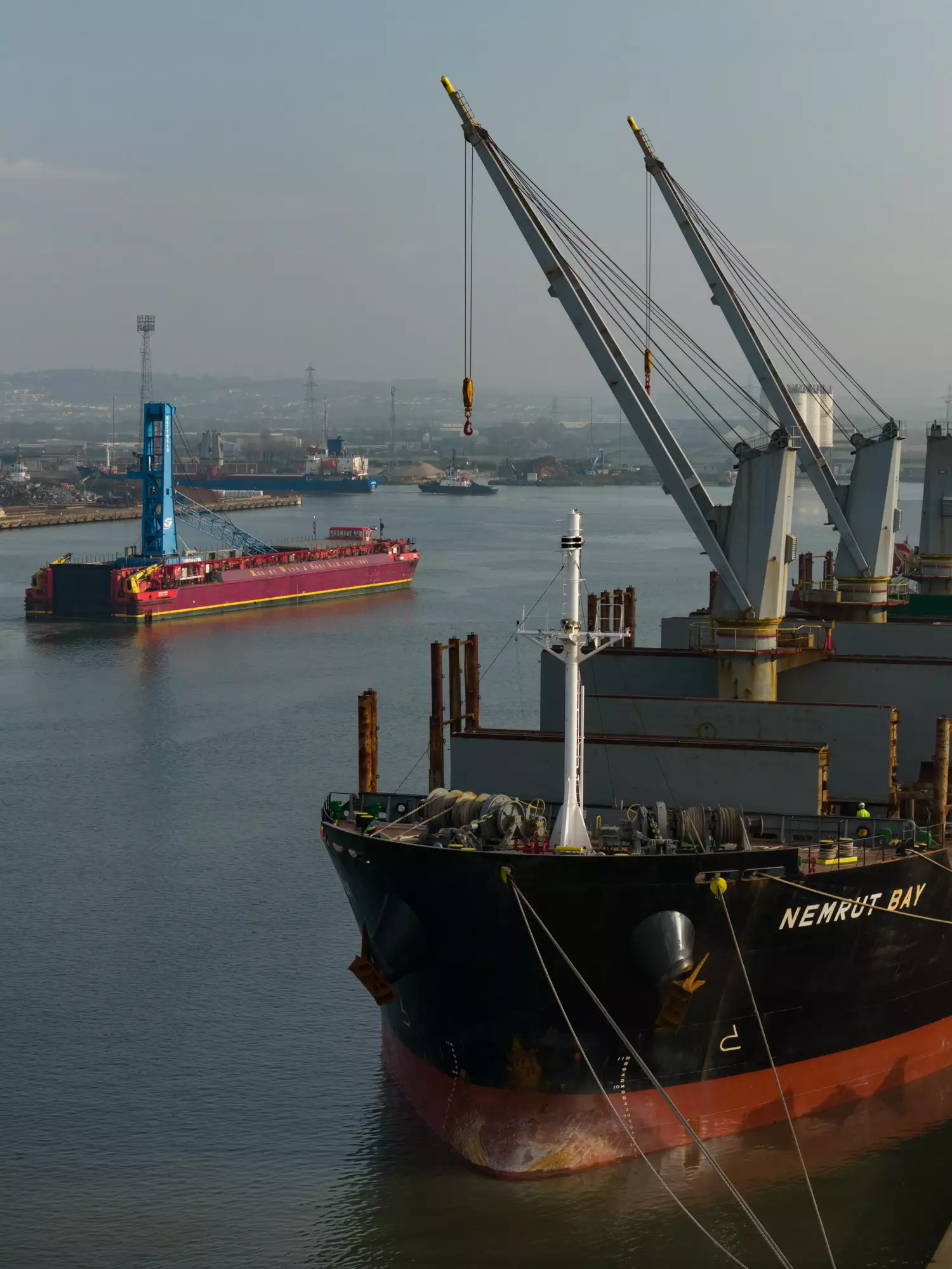 Aerial view of the Robert Wynn and Sons barge carrying crane Margaret into the Port of Newport
