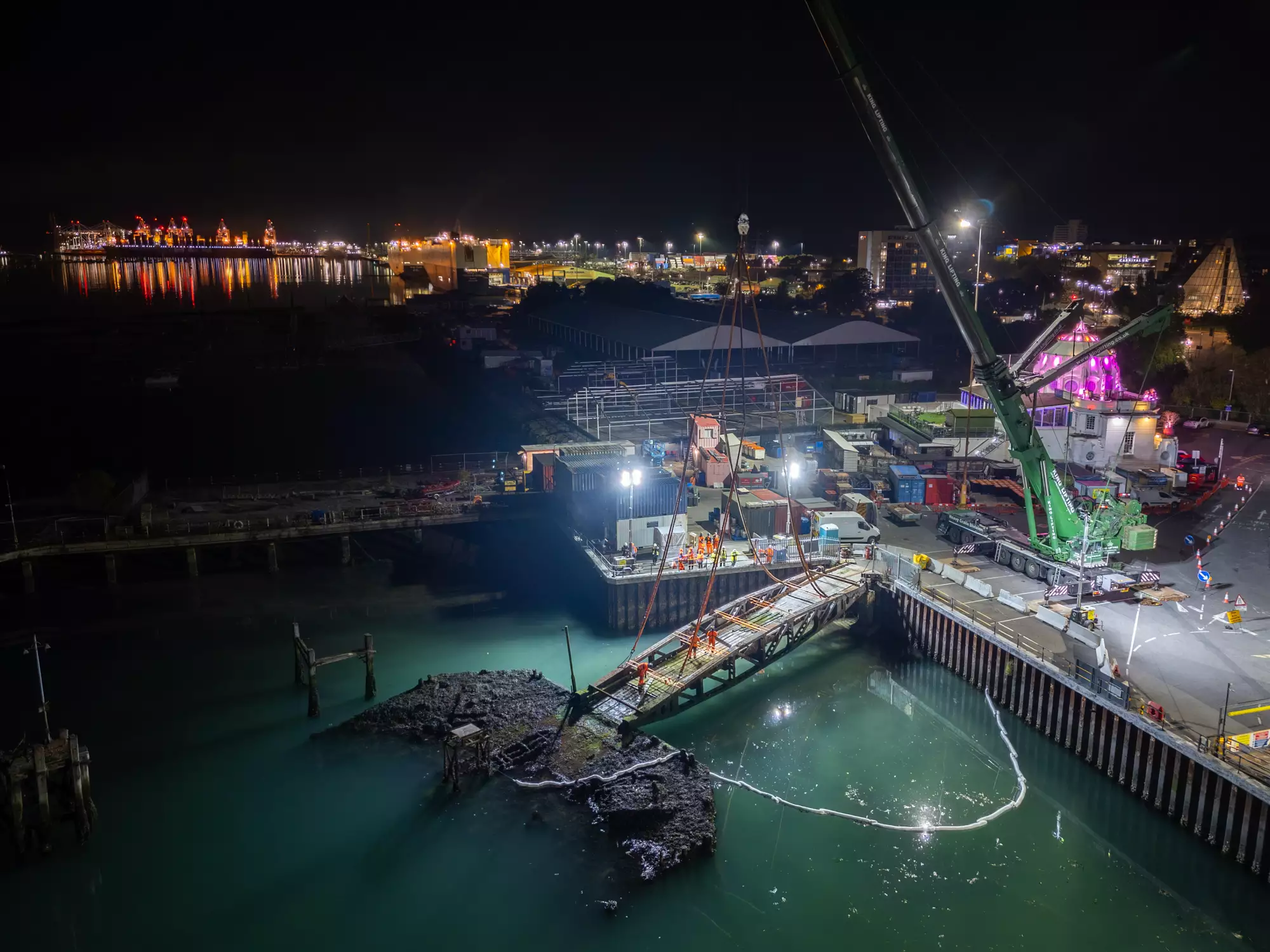 Night drone view of the D-Day Whale bridge beside Royal Pier, Southampton, before its heritage lift by ABP